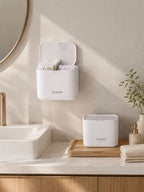 Wall-mounted and countertop cotton swab organizer in a bright bathroom