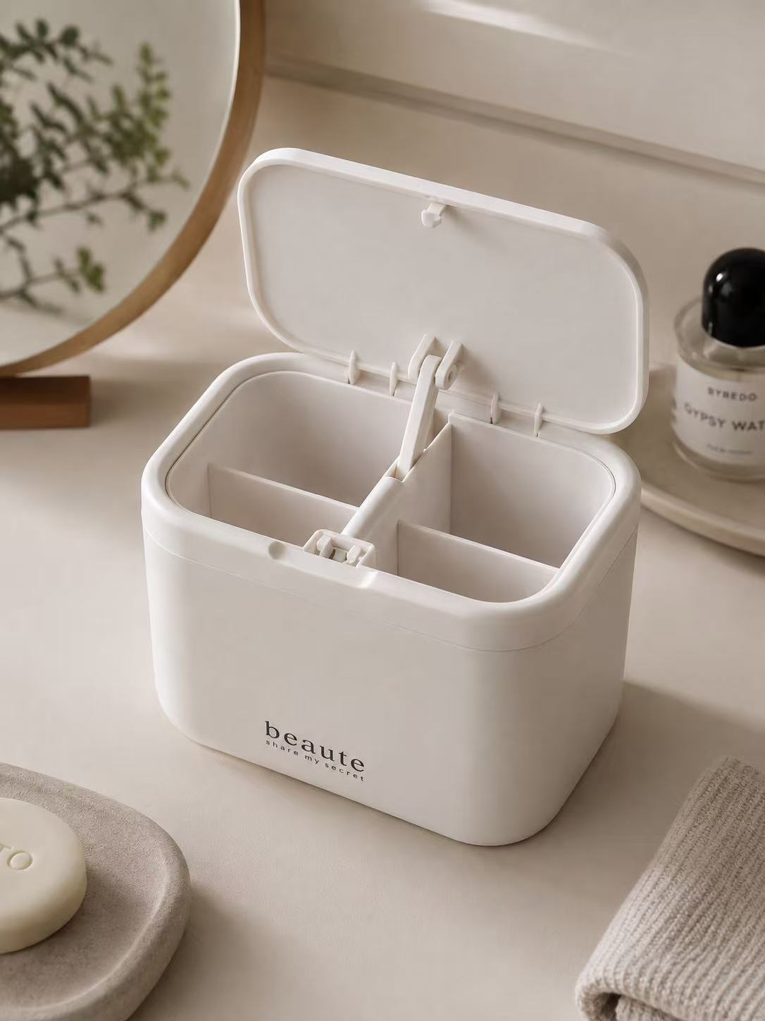 White wall-mounted cotton swab and pad organizer with lid open and four compartments