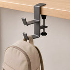 Dual-hook desk clamp holding a backpack