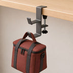 Dual-hook desk clamp holding a handled bag
