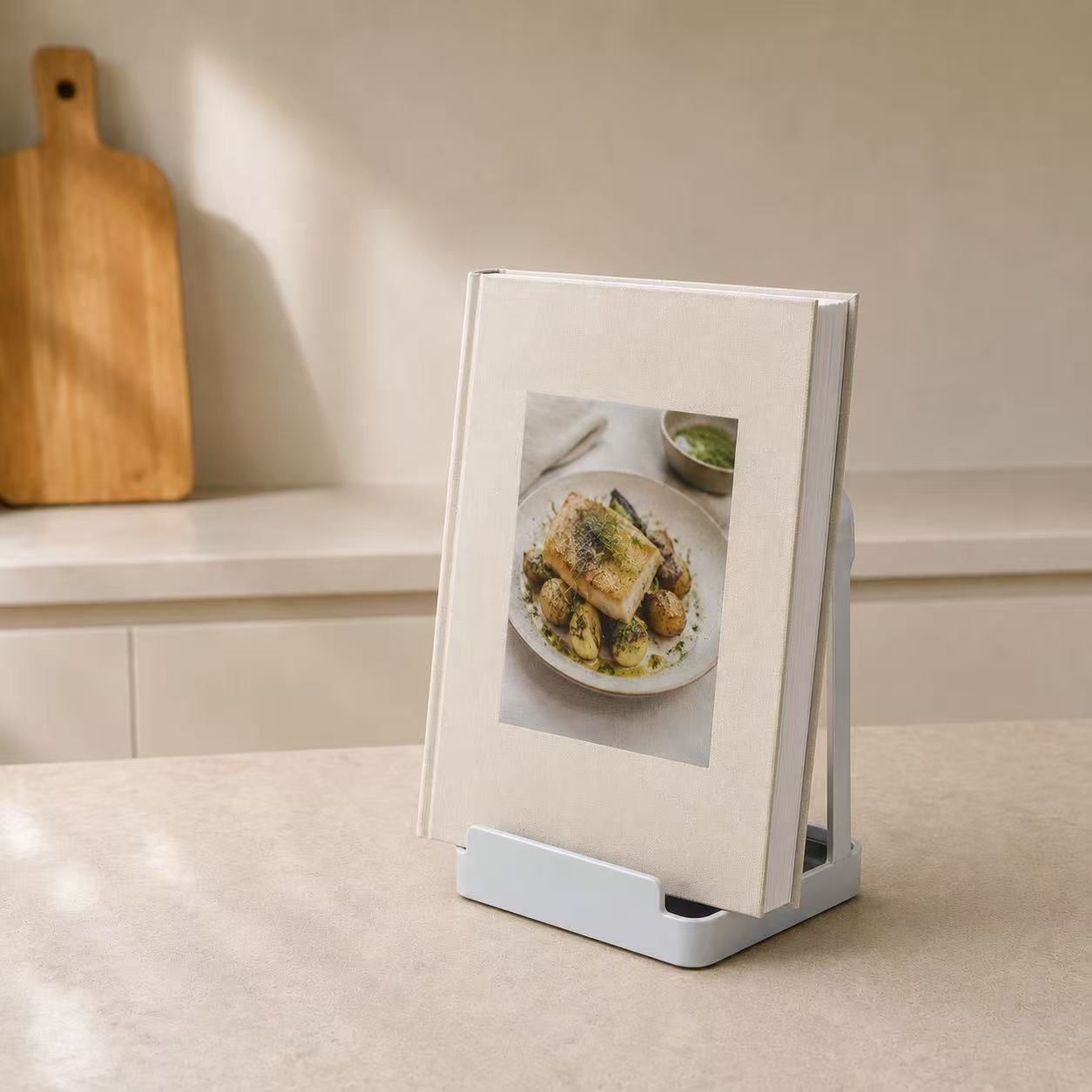 White multifunctional kitchen stand holding a cookbook on a countertop