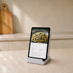 White multifunctional kitchen stand holding a tablet with a recipe