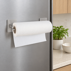 Silver two-piece magnetic paper towel holder mounted horizontally on a kitchen refrigerator