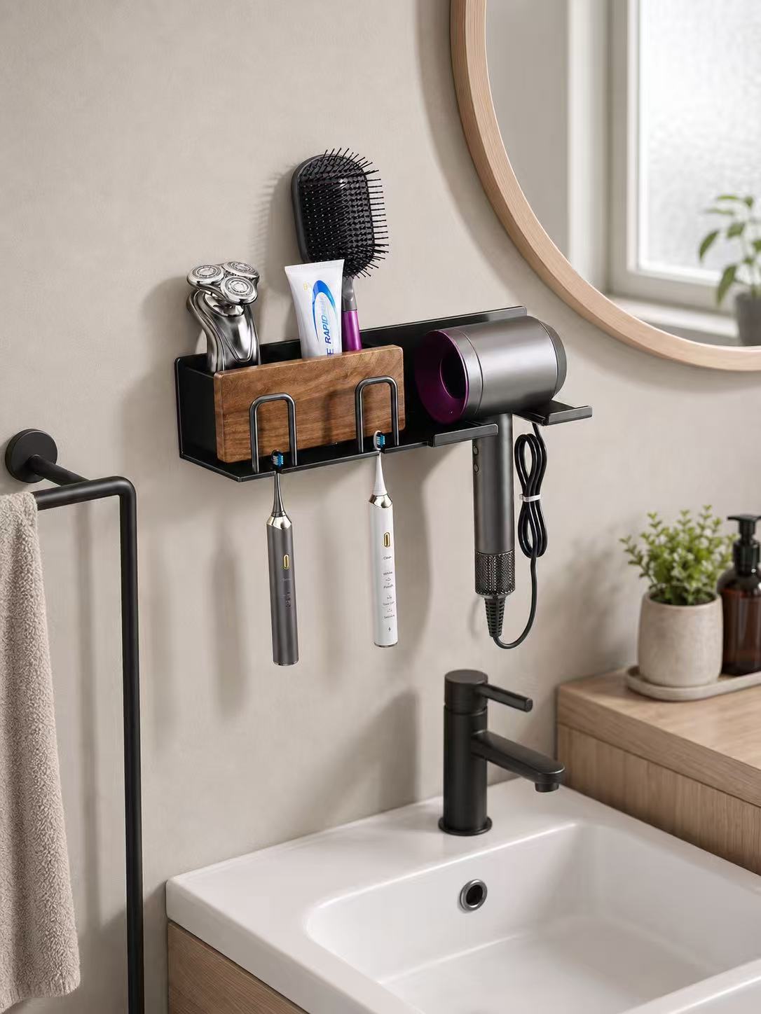 Compact black wall-mounted bathroom organizer with two toothbrush holders and a hair dryer bracket