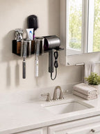 Black bathroom organizer with covered toothbrush cups and hair dryer holder mounted beside a mirror