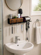 Black wall-mounted bathroom organizer with three toothbrush slots, storage shelf and hair dryer holder